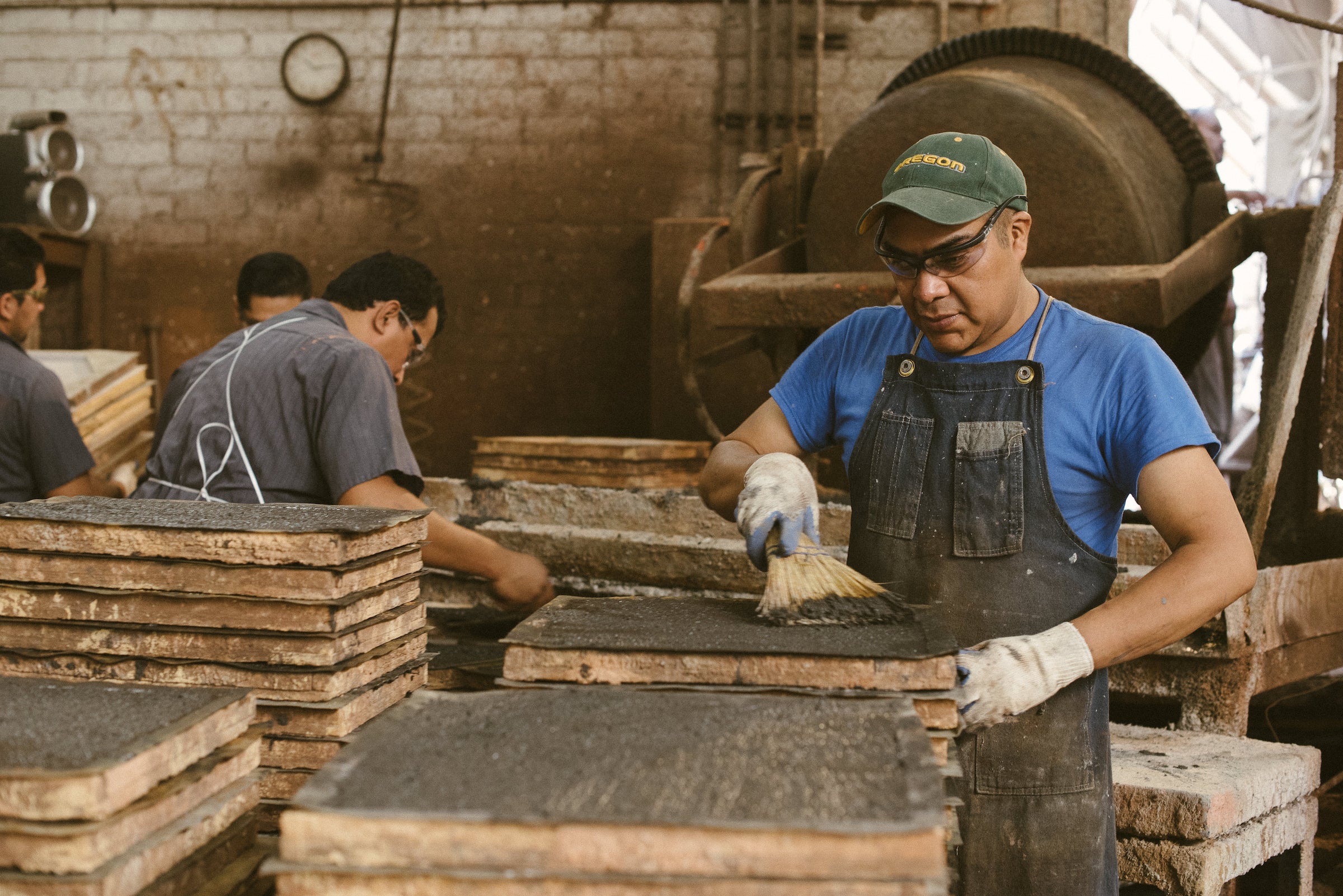ARTO makers finishing cast concrete tile on the factory floor