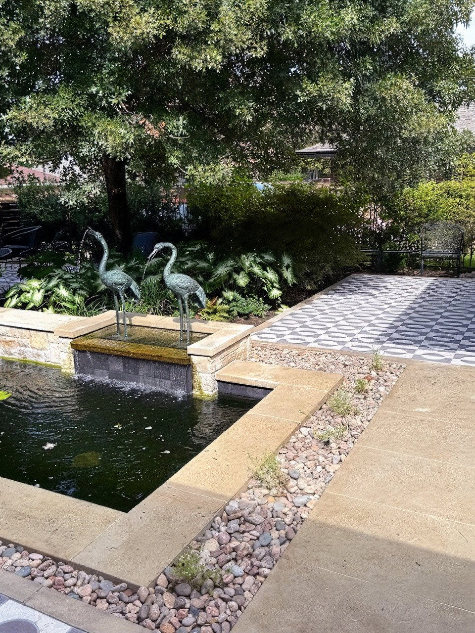 Pond fountain beside the tiled path