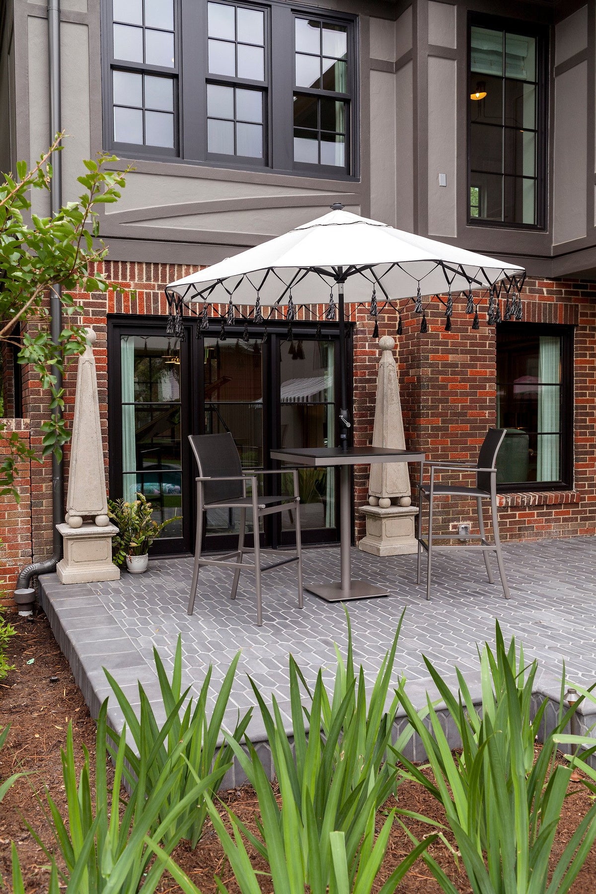 Picket patio beside the brick house