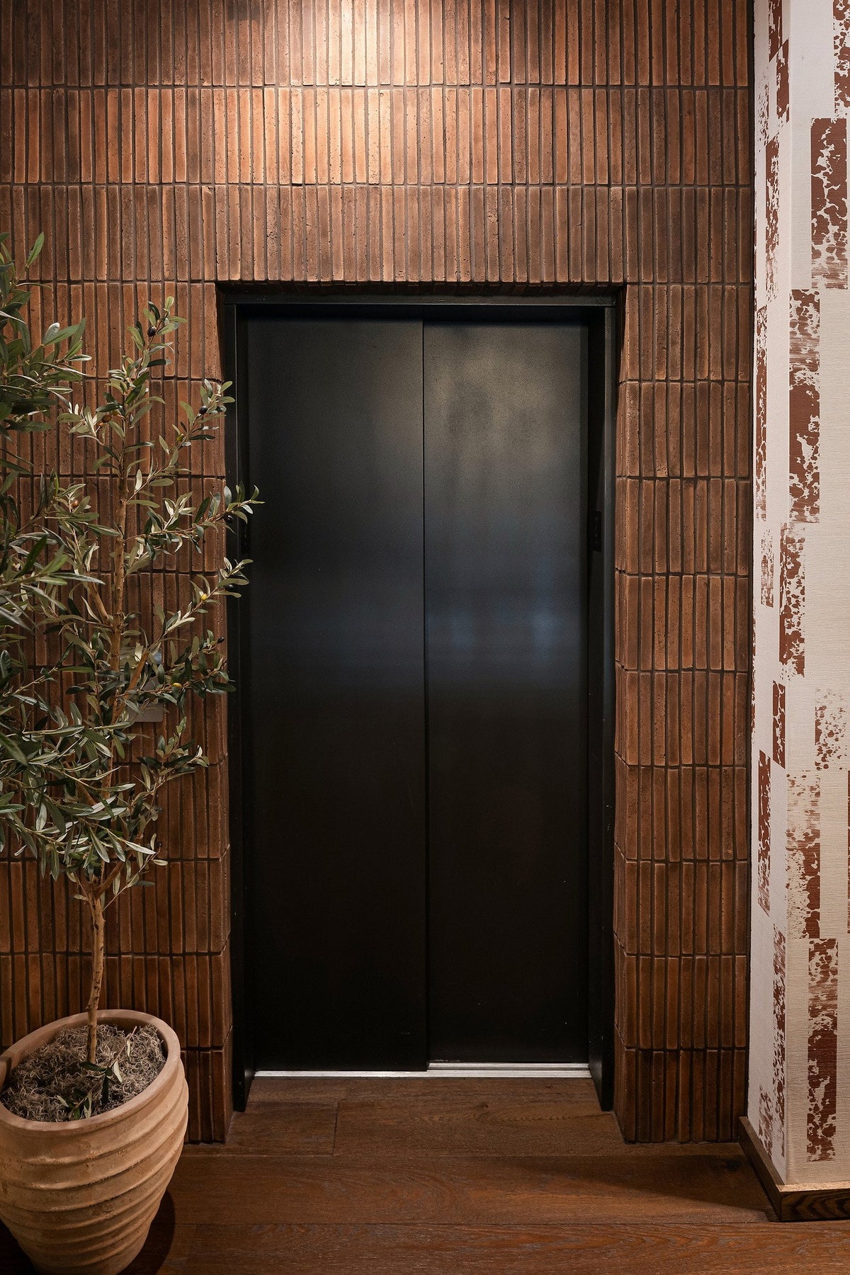 Elevator framed in Cotto Gold
