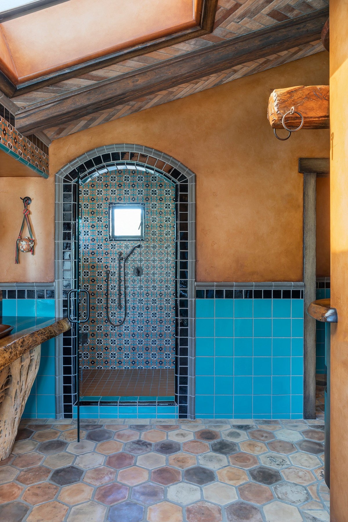 Arched shower beside the hex floor