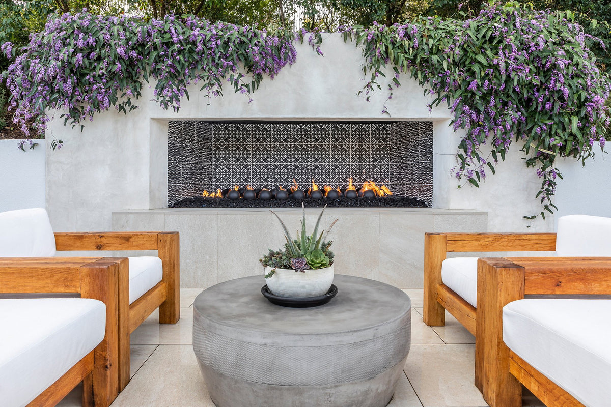 Outdoor fireplace lined in deco tile