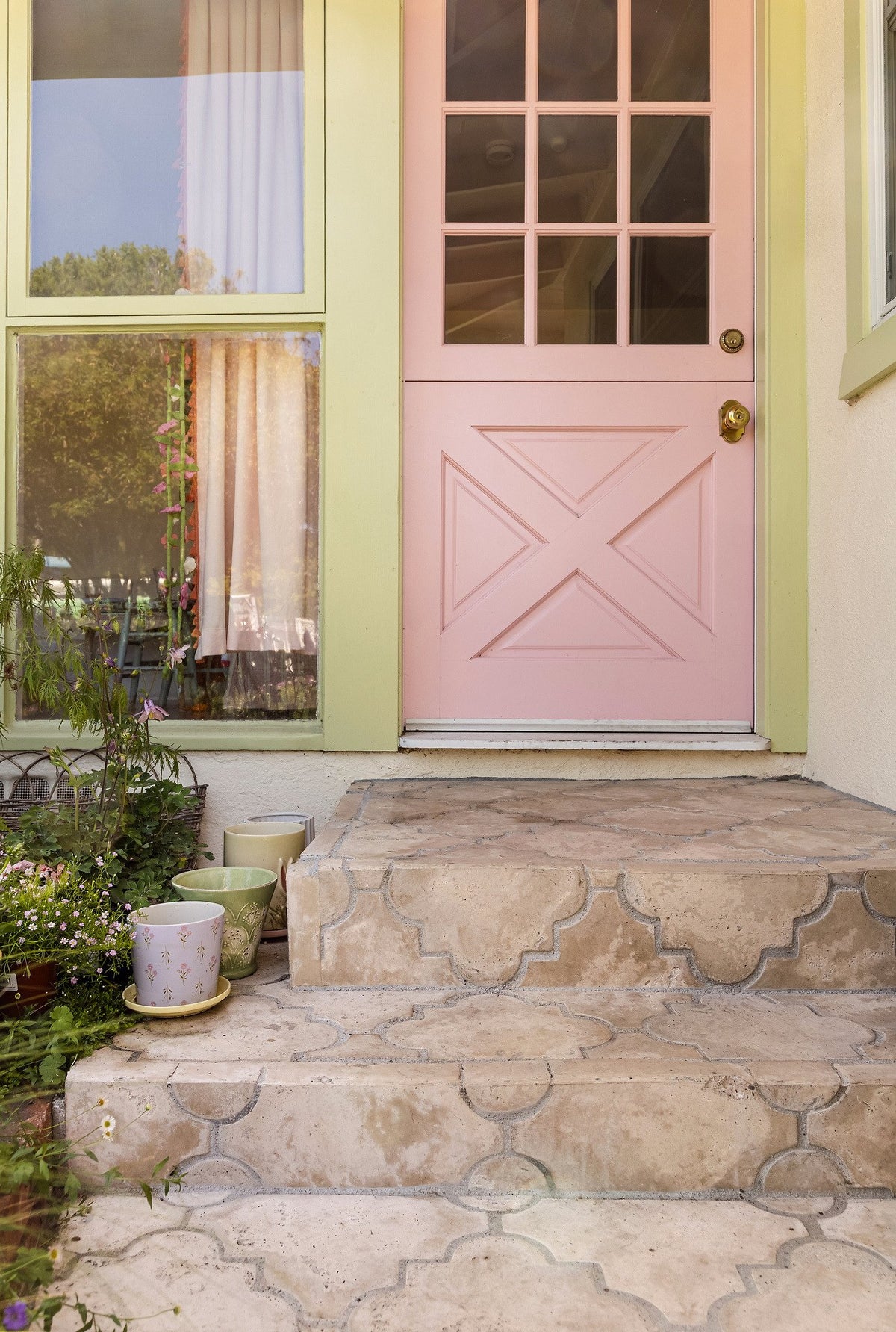 Tiled steps at the pink front door