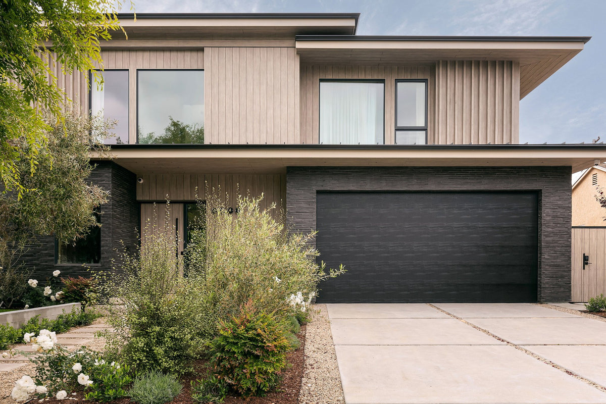 Two-story home with Charcoal brick base