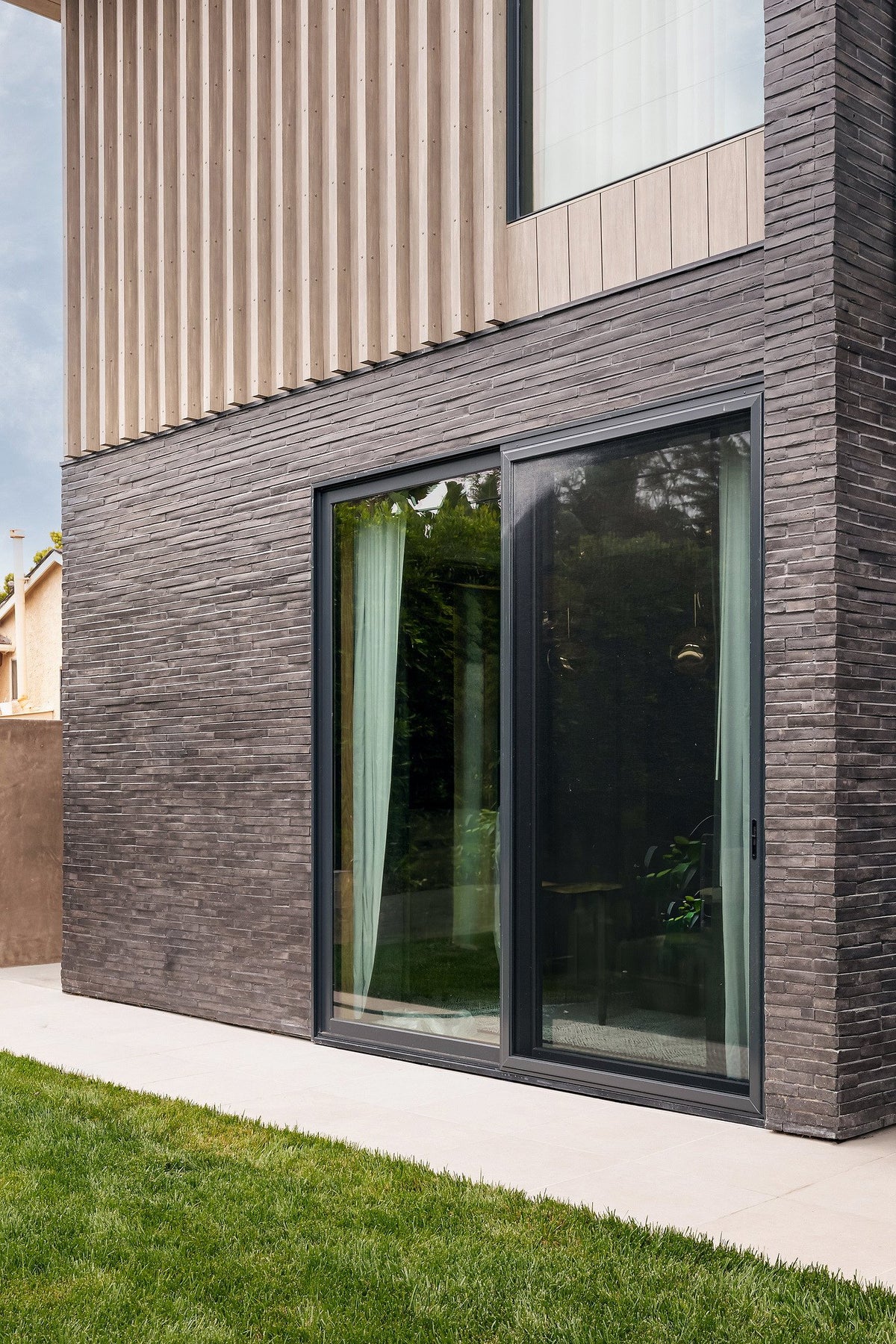 Sliding door in a Charcoal brick wall