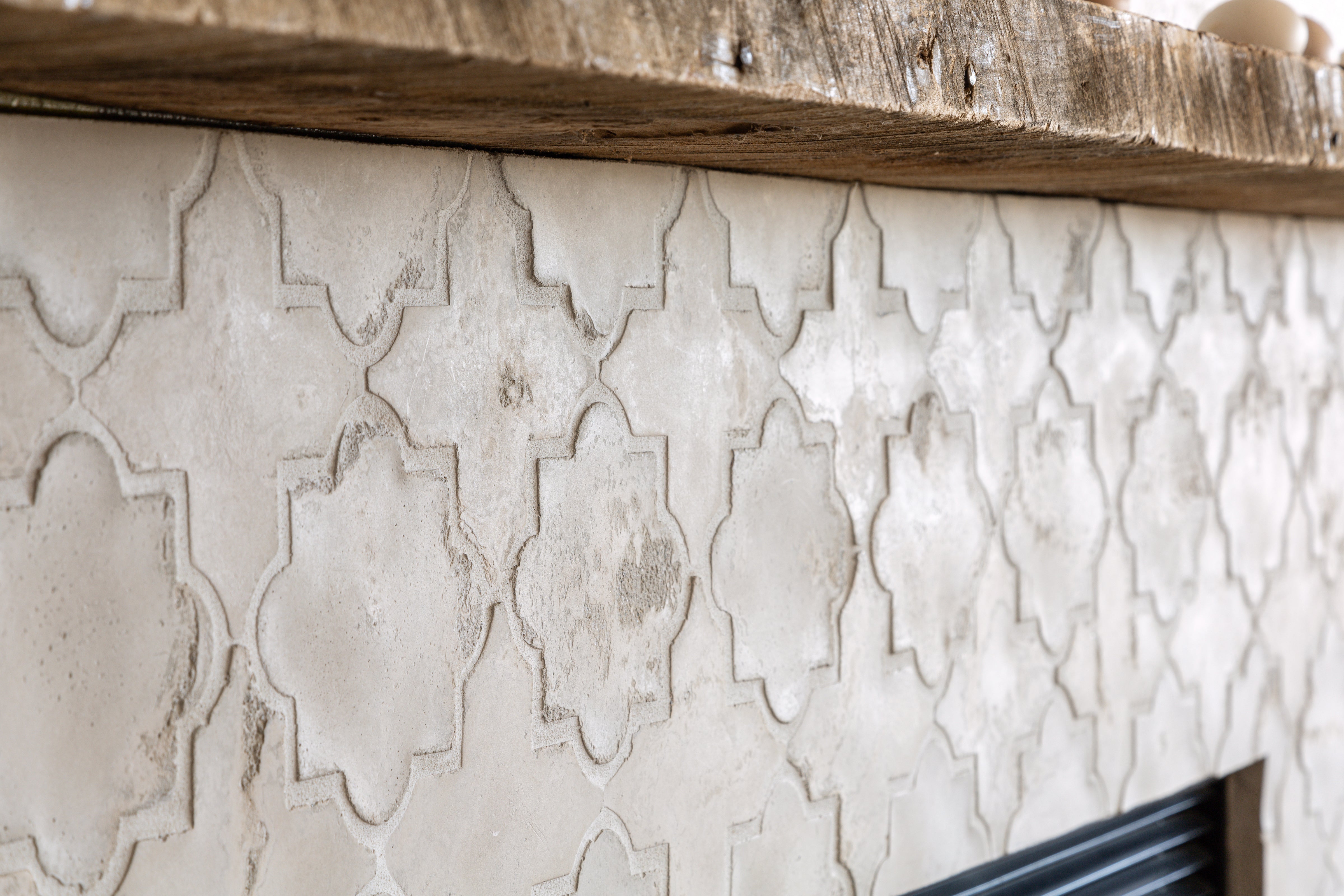 A fireplace faced in ARTO Artillo Arabesque in Early Gray