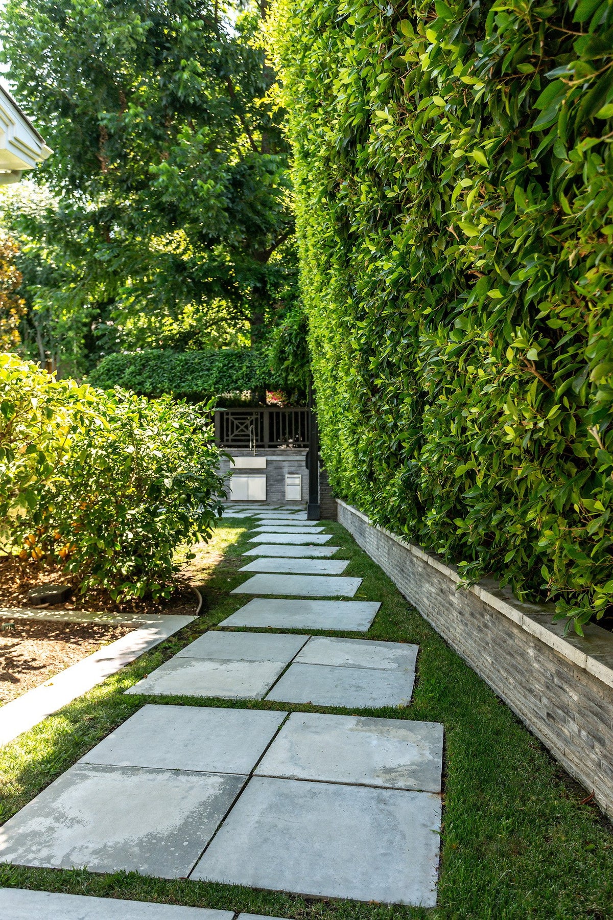 Garden path beside a brick wall
