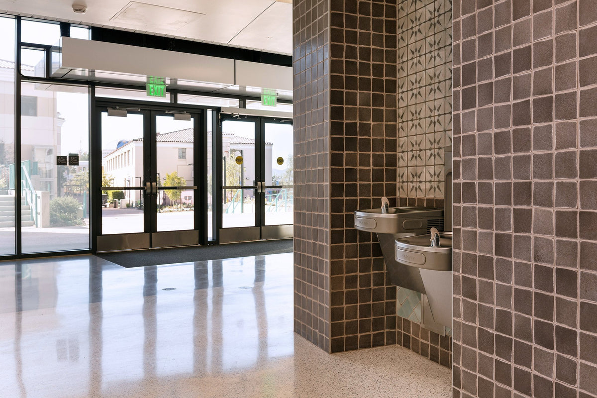 Gray tile wall by the entry doors