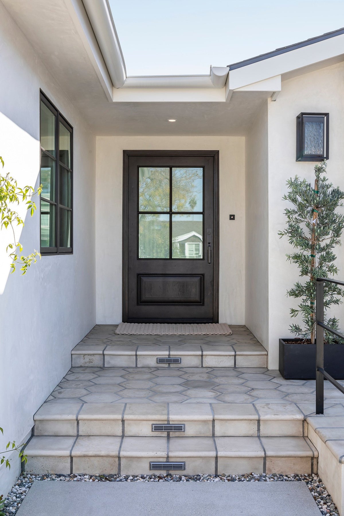 Front door with tiled stairs