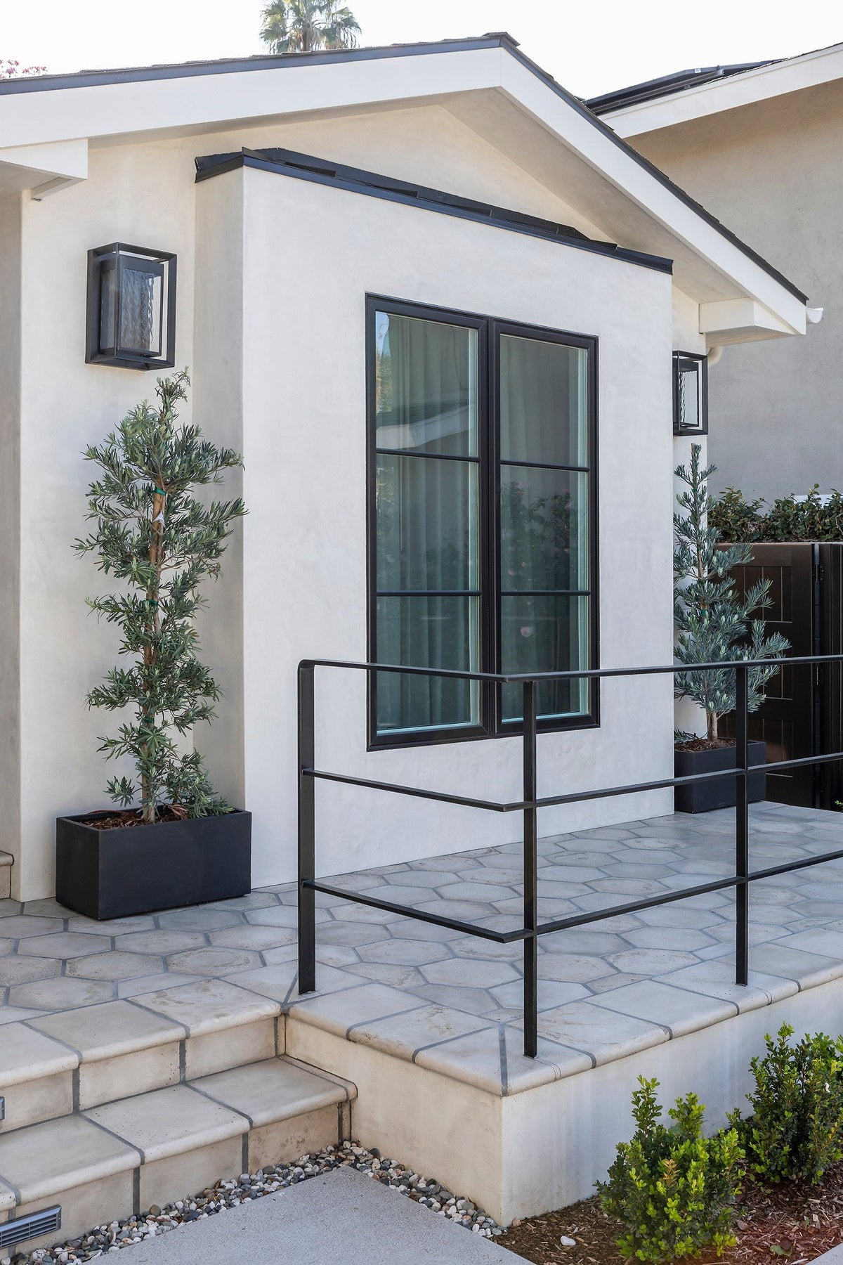 Raised porch with iron railing