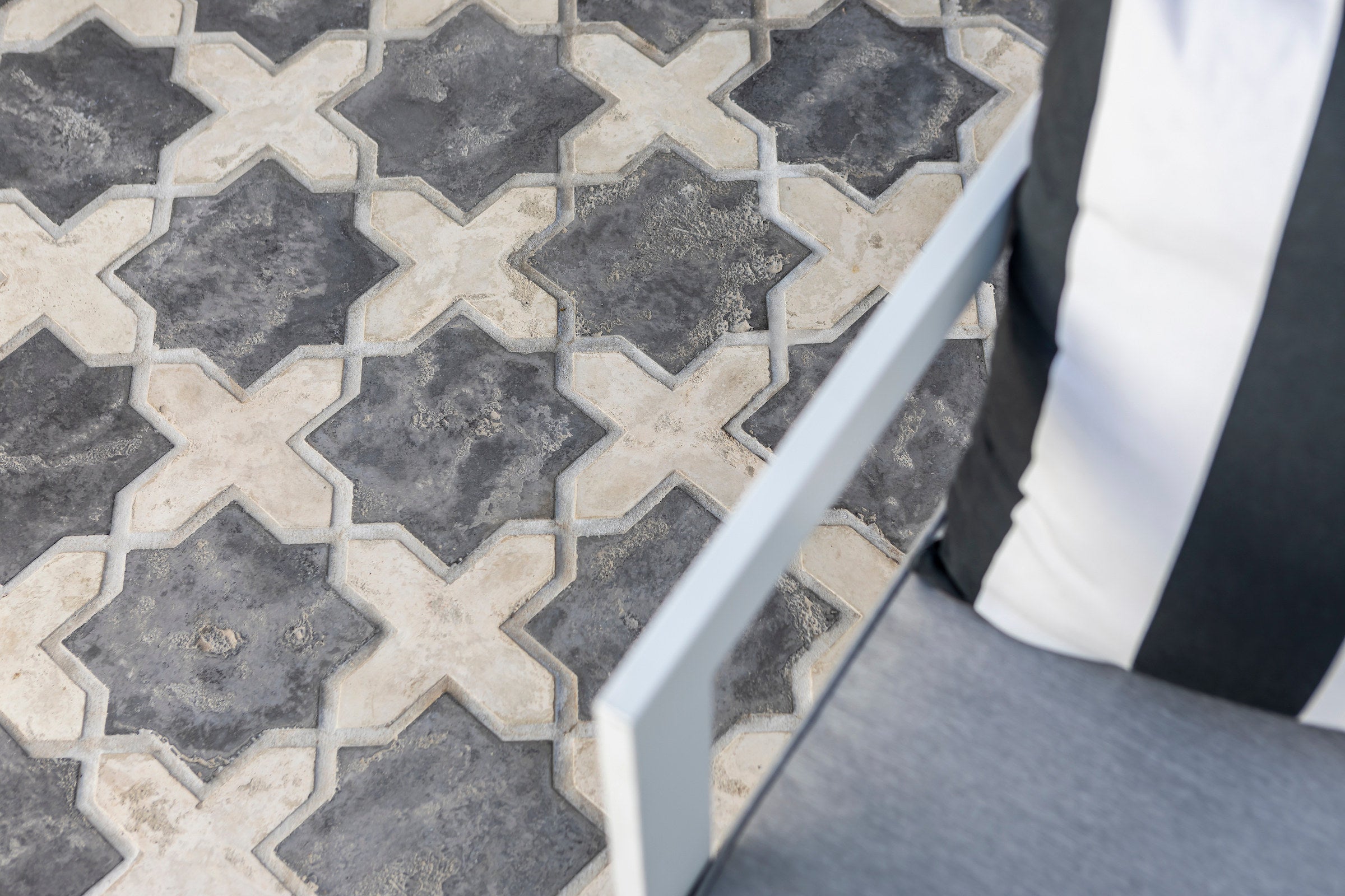 A floor of ARTO star and cross tile in cream and charcoal, seen close