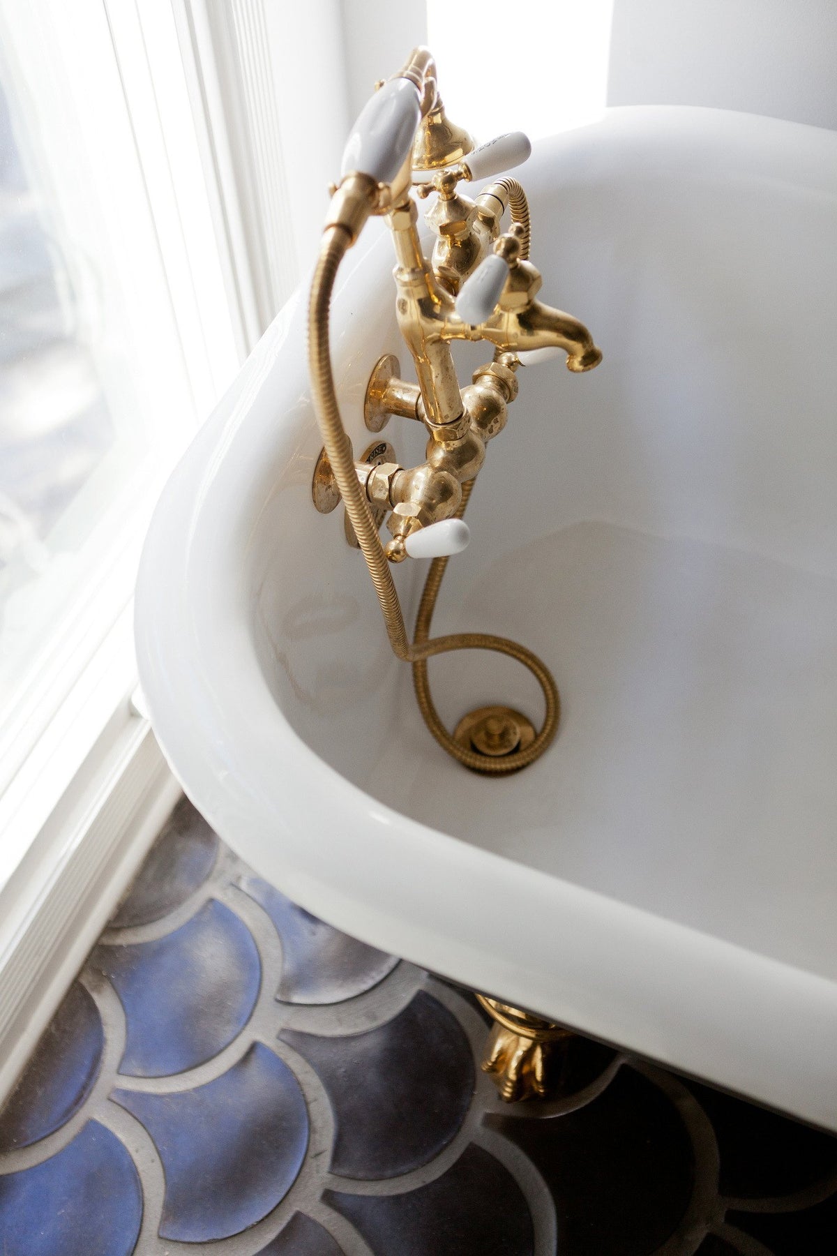 Gold tub filler over Conche tile