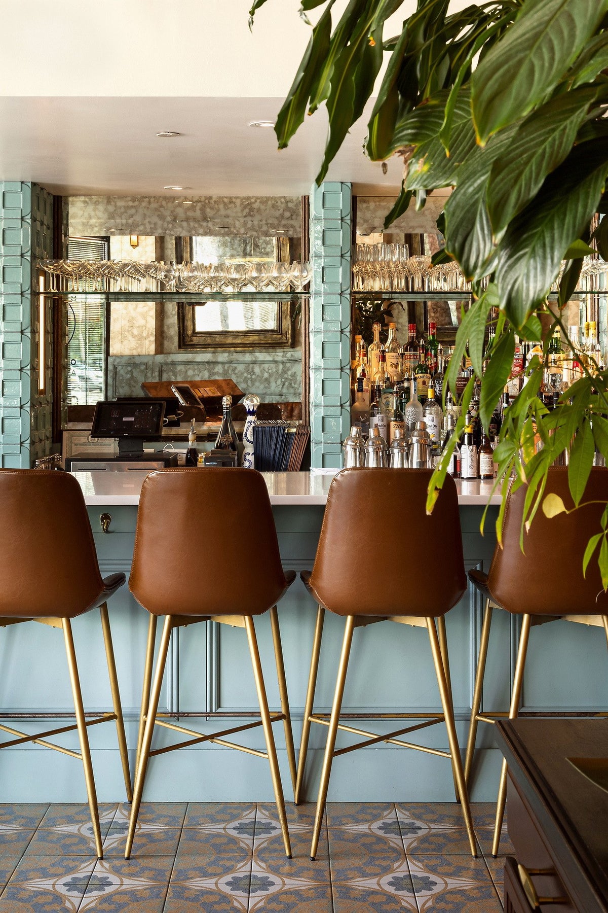 Leather stools at the tiled bar