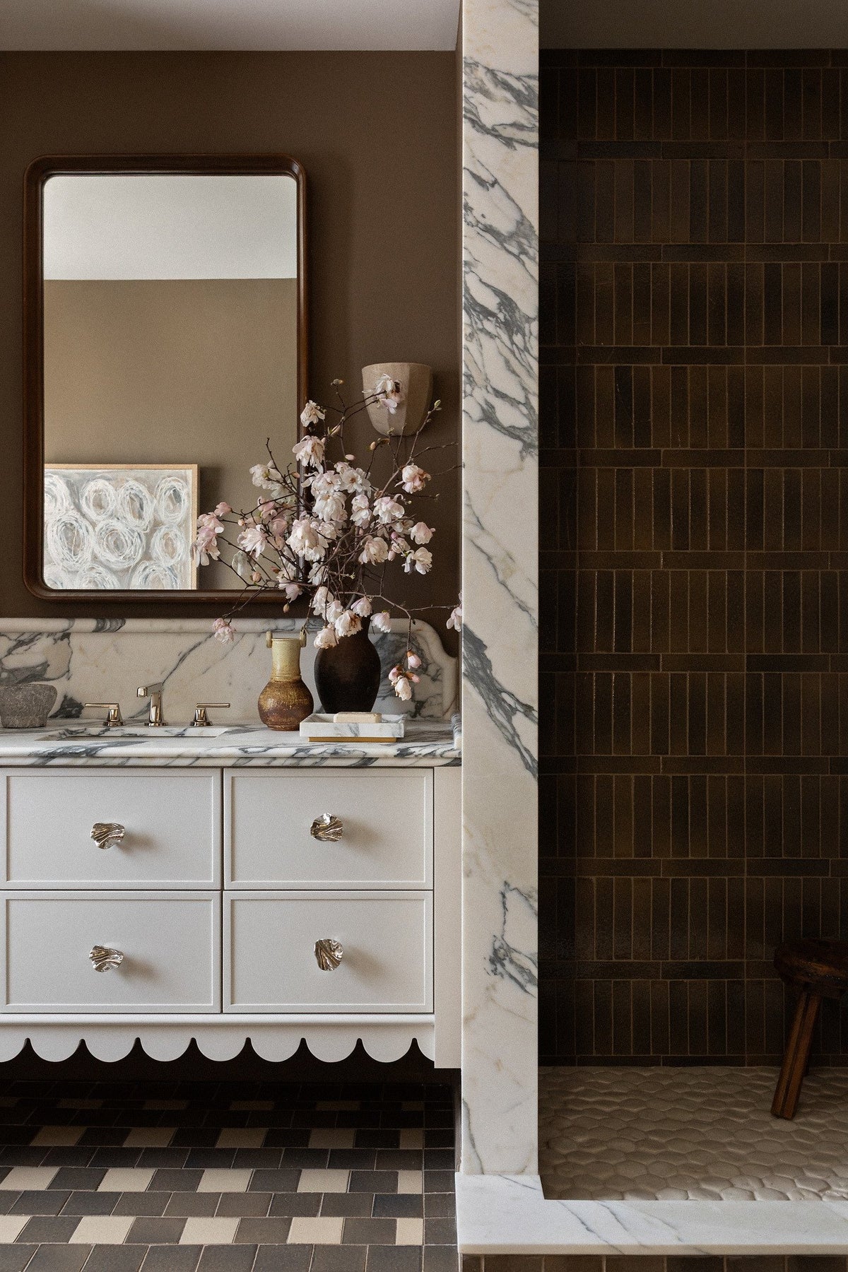 Vanity, checkered floor and tiled shower