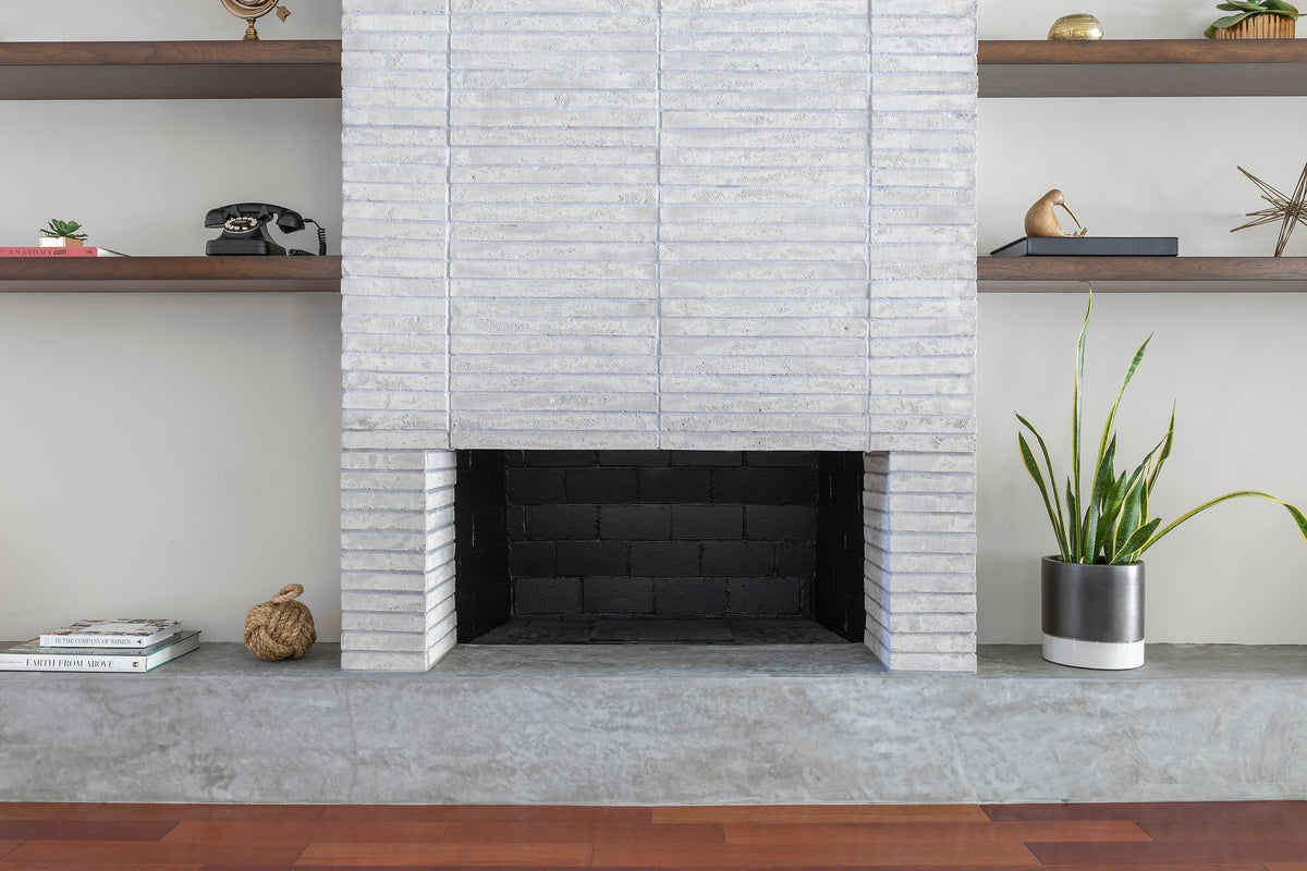 Fireplace between open wood shelves