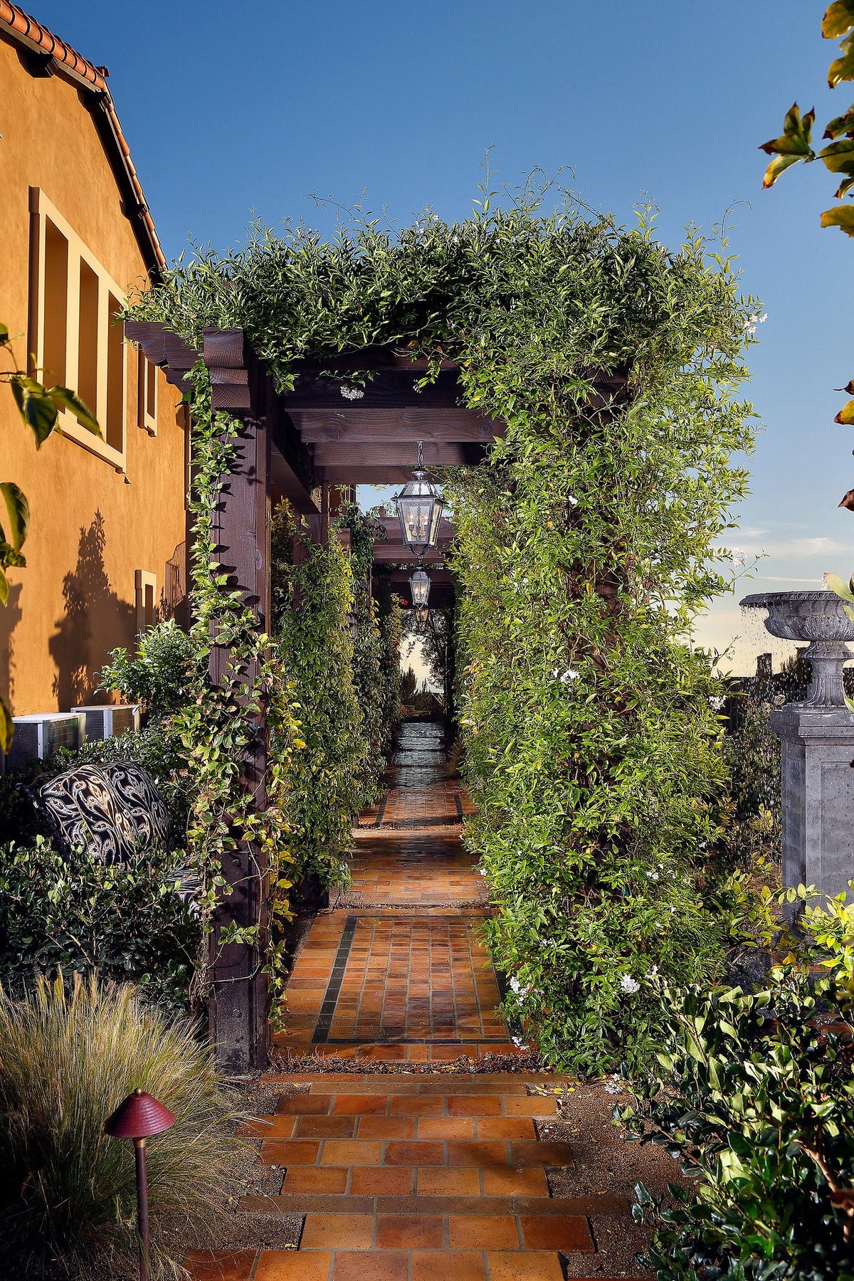 Tiled garden path under an arbor