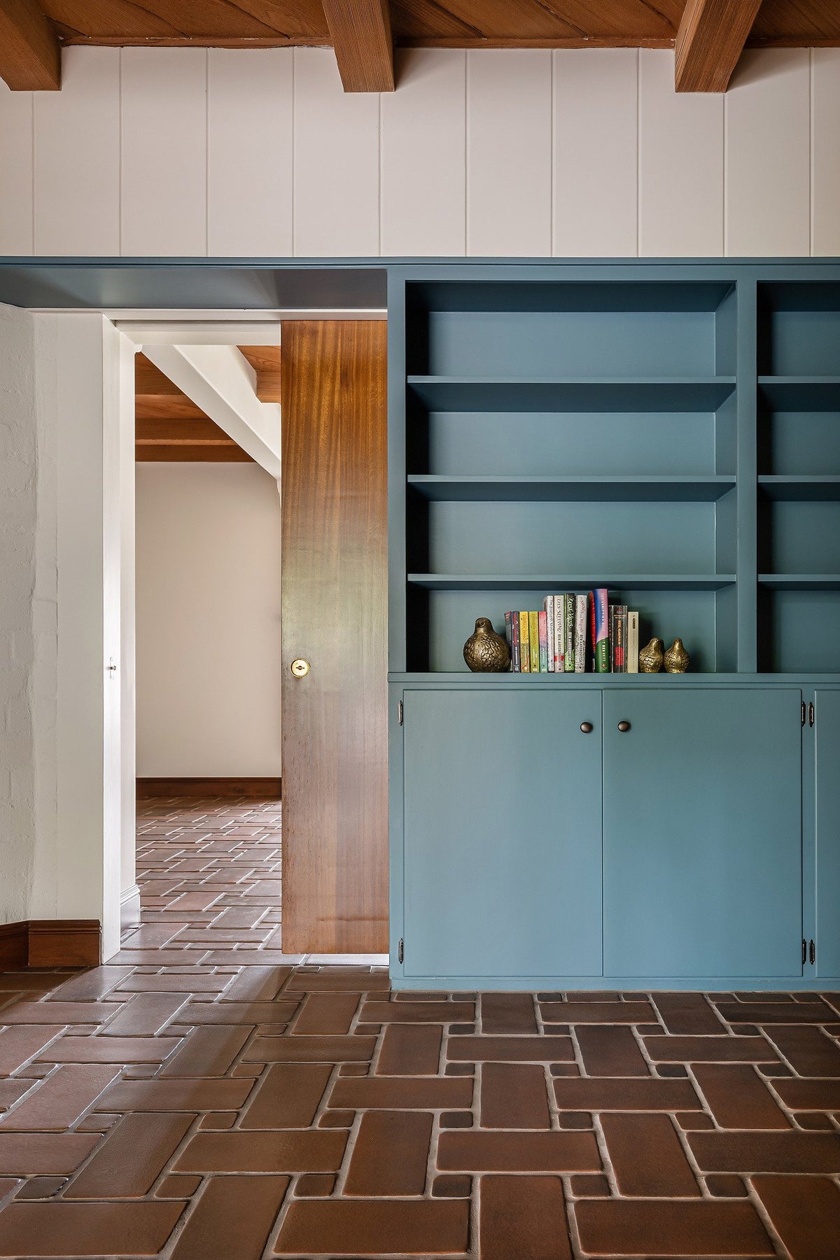 Blue bookcase and basketweave floor