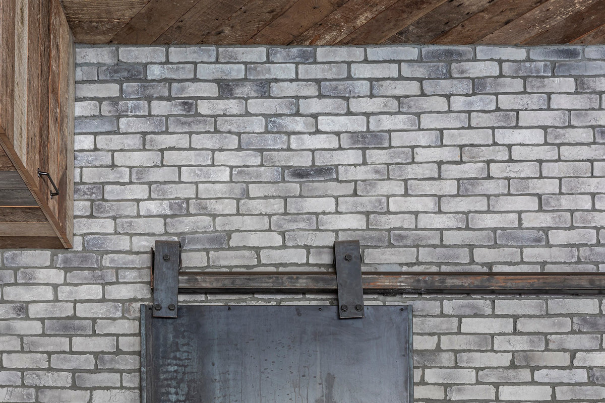 Running-bond brick below wood beam