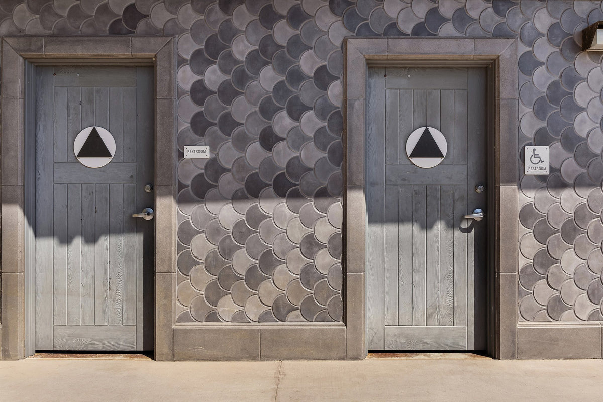 Conche tile between restroom doors
