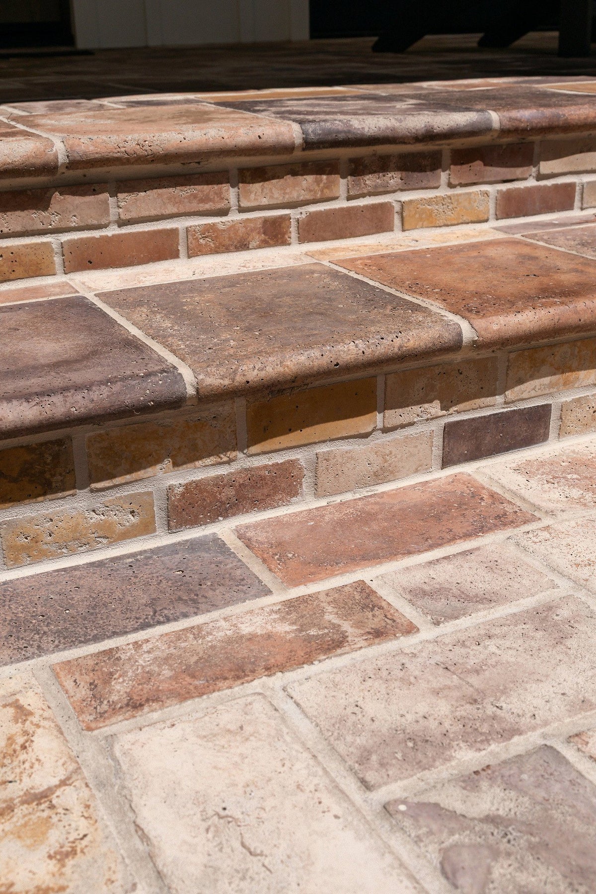 Stair tread edge over brick riser