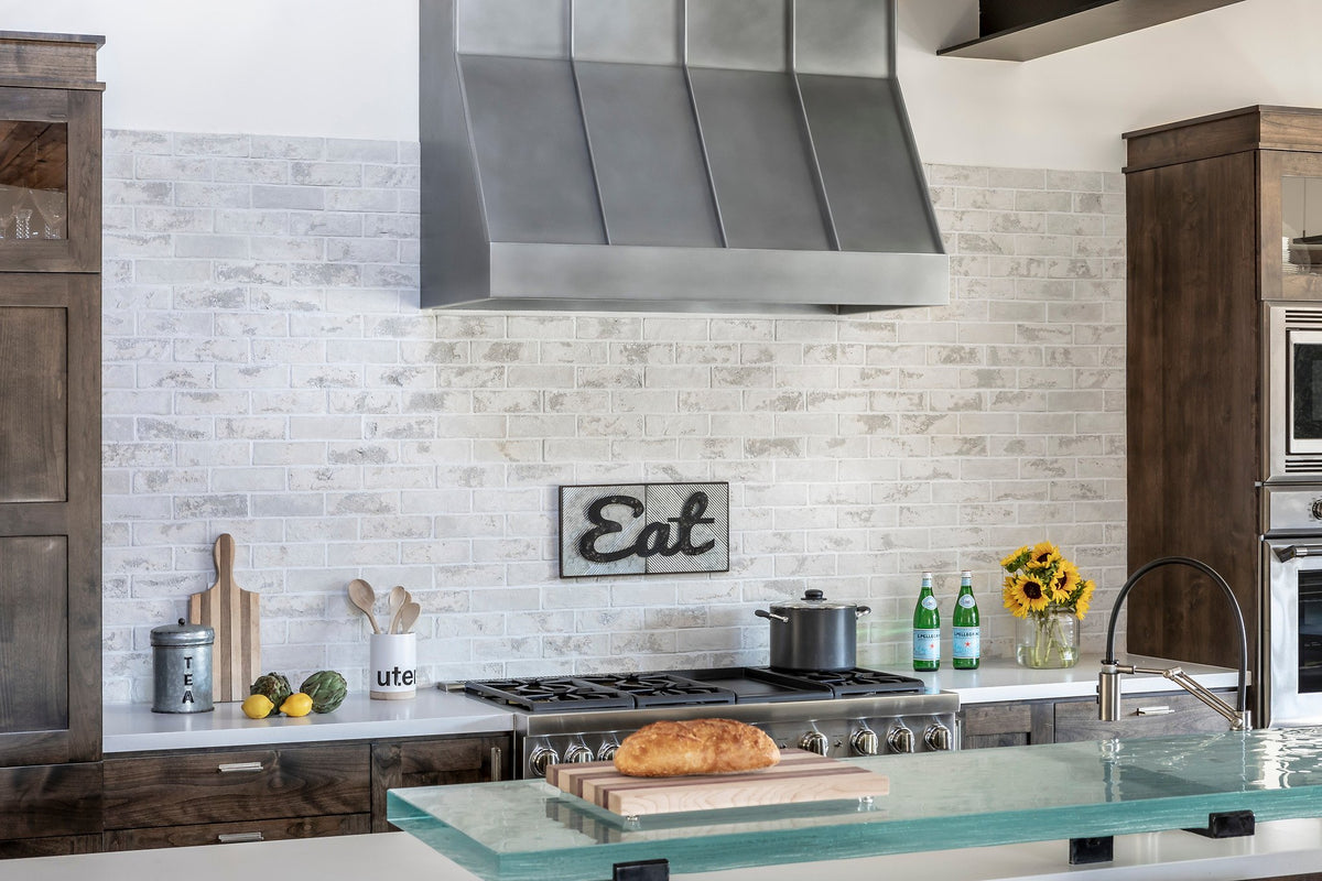 Brick wall behind the steel hood