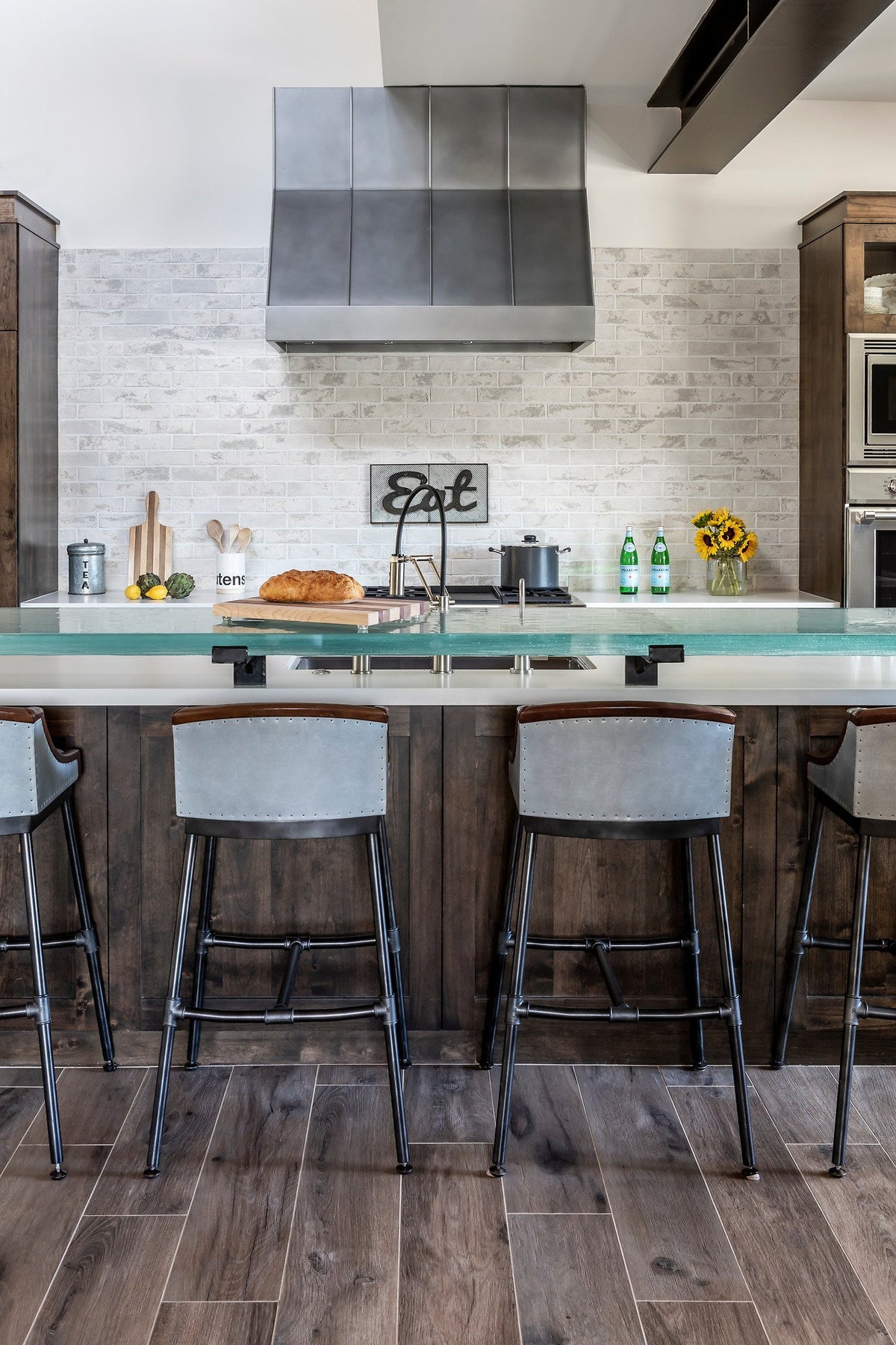 Island seating facing the brick wall