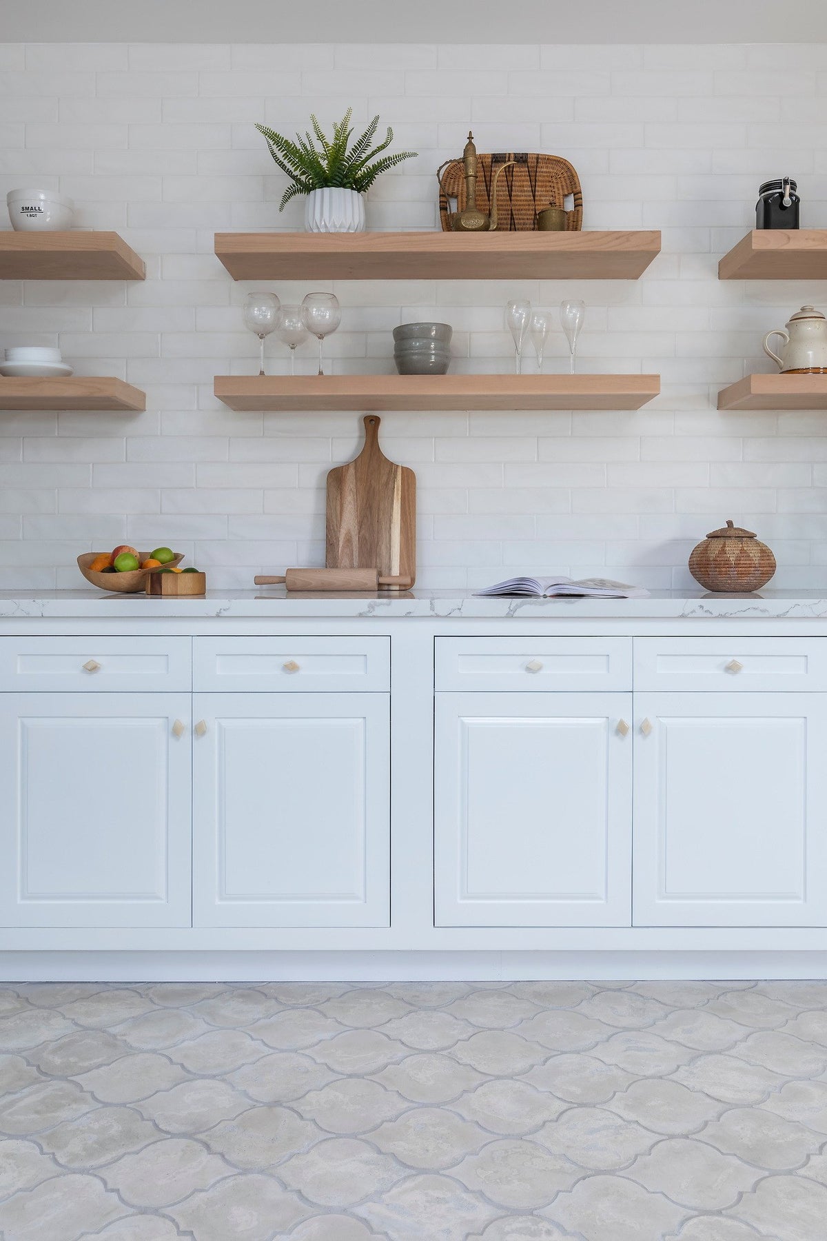 Arabesque floor below white cabinets