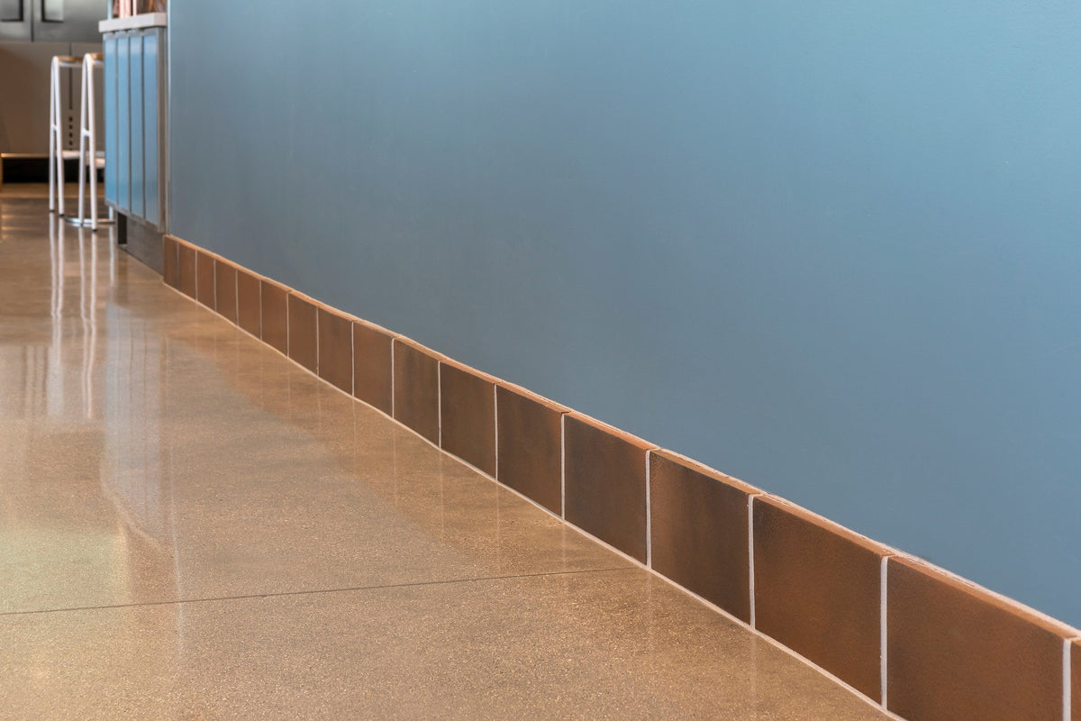 Tile base along the blue wall