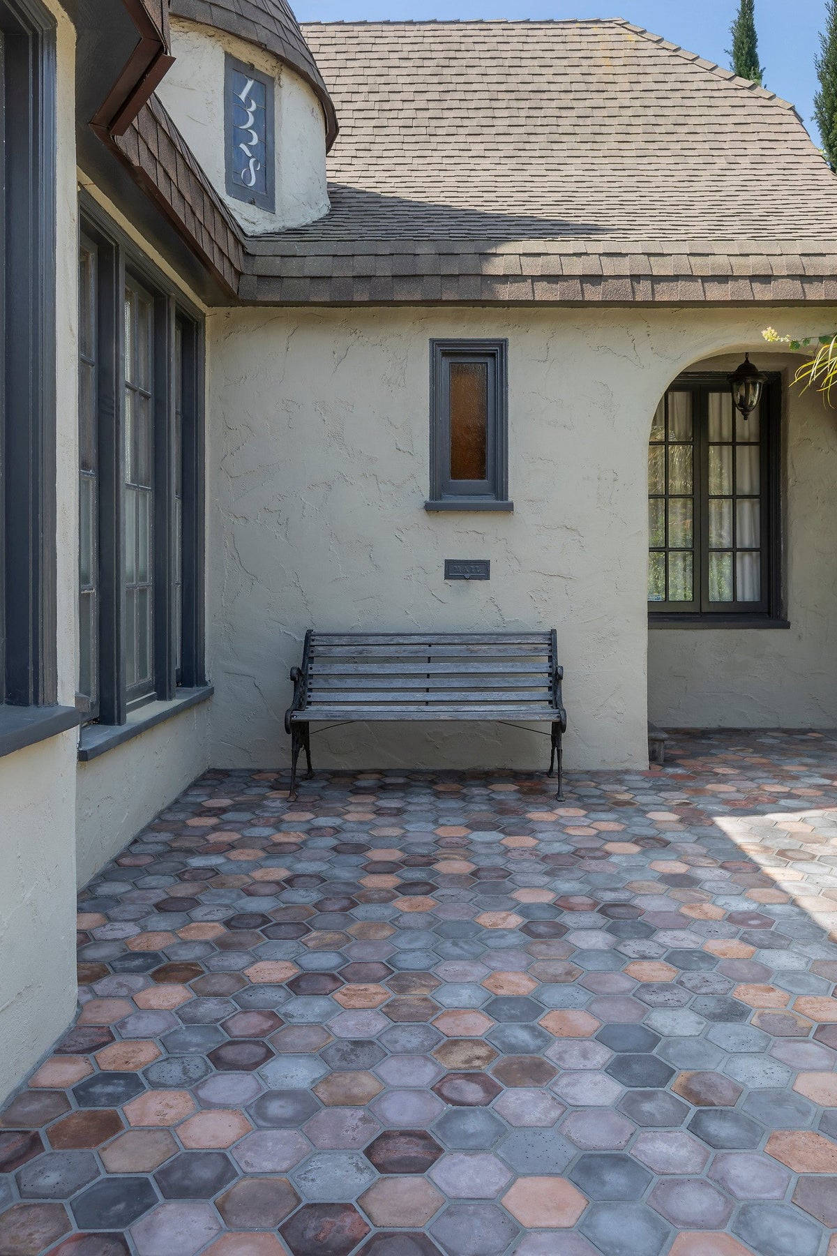 Tudor courtyard with hexagon tile patio